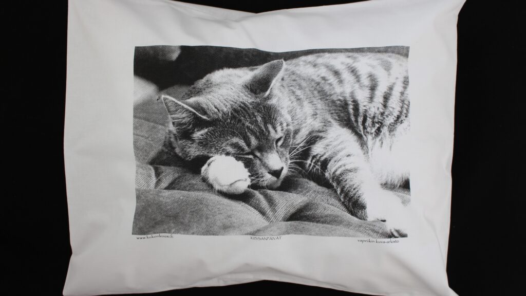 Cotton pillowcase featuring a photograph of a sleeping cat.